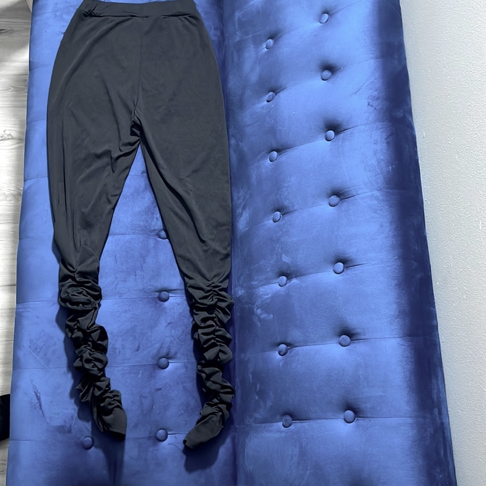 All black leggings stacked at the bottom